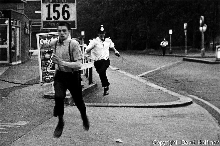 Police chase skinhead during rioting in Wood Green, July 1981.